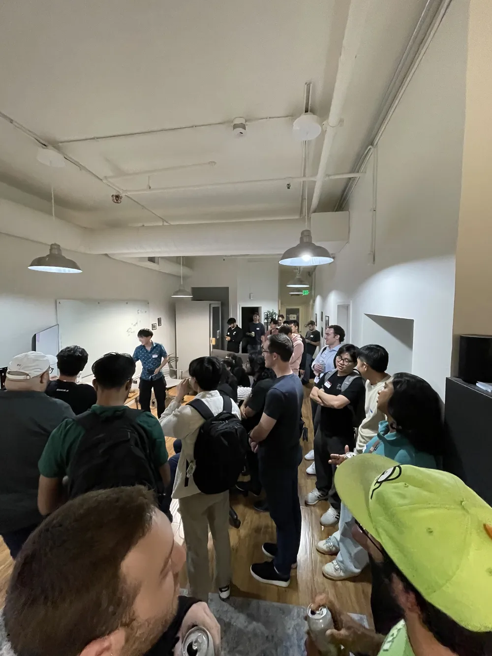 A packed room of attendees at the Dosu office facing the front of the room